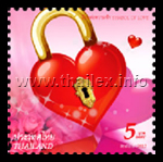 a lock in the form of a red heart with some pink roses in the background